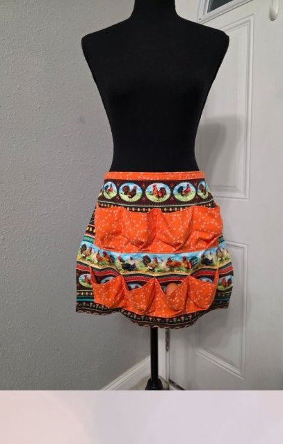 Bright orange egg apron with a festive print
